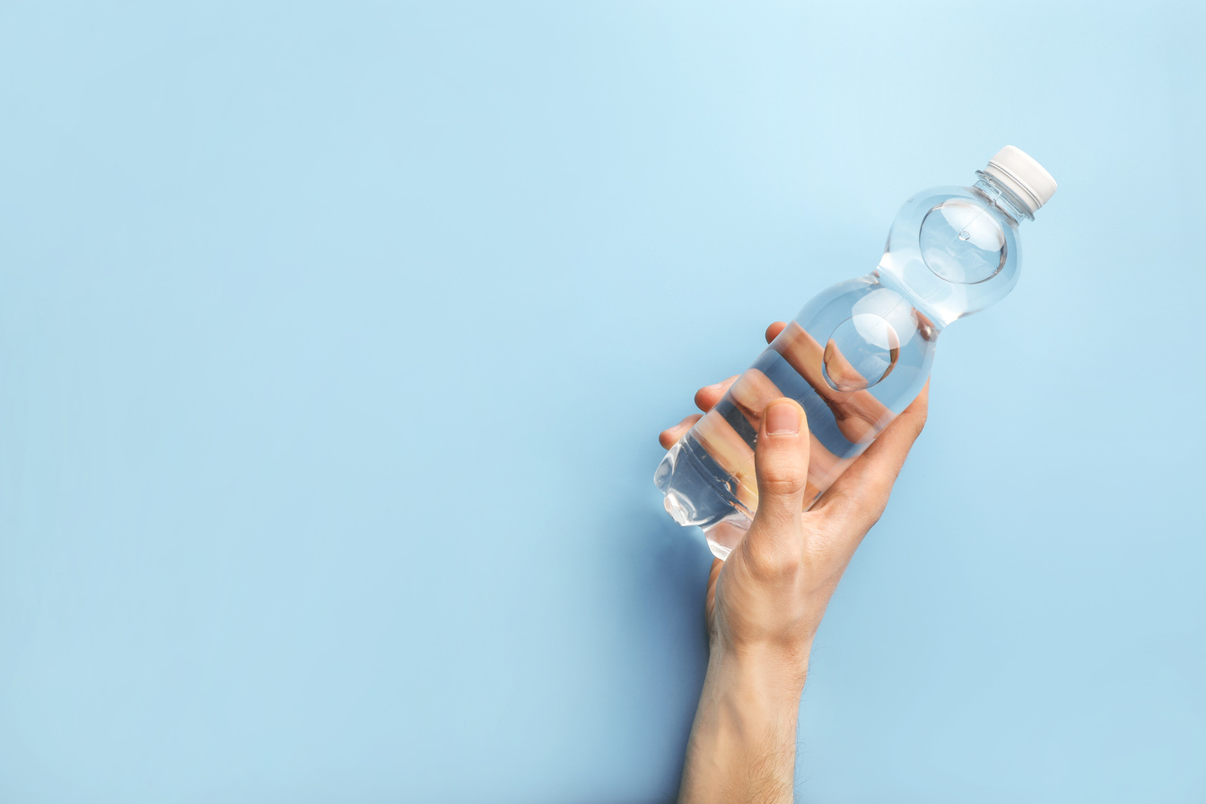 Hand holding plastic water bottle
